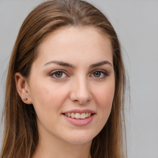 Joyful white young-adult female with long  brown hair and brown eyes