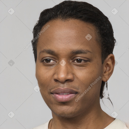 Joyful black young-adult male with short  black hair and brown eyes