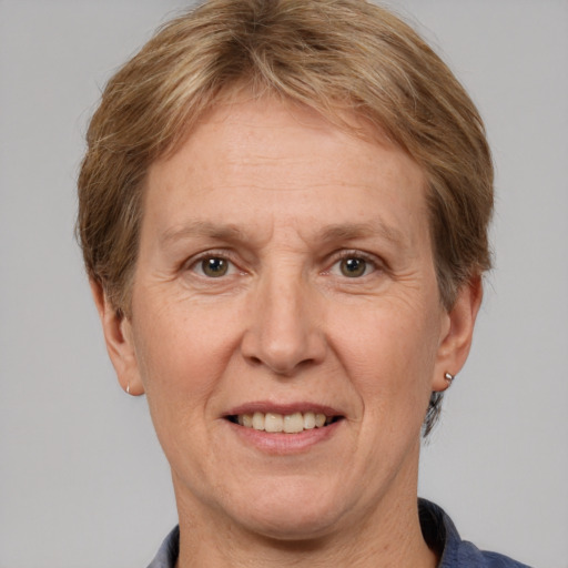 Joyful white adult female with short  brown hair and grey eyes