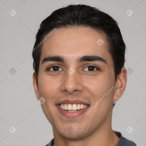 Joyful white young-adult male with short  black hair and brown eyes