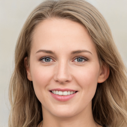 Joyful white young-adult female with long  brown hair and grey eyes