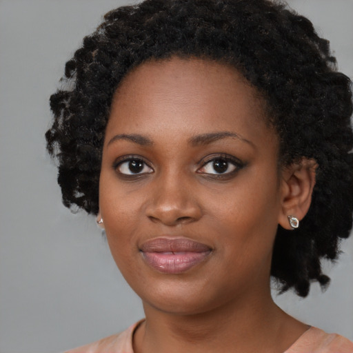 Joyful black young-adult female with medium  black hair and brown eyes