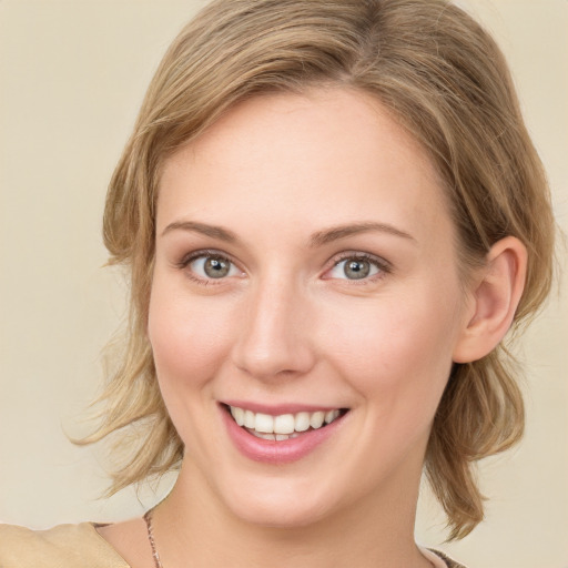 Joyful white young-adult female with medium  brown hair and green eyes