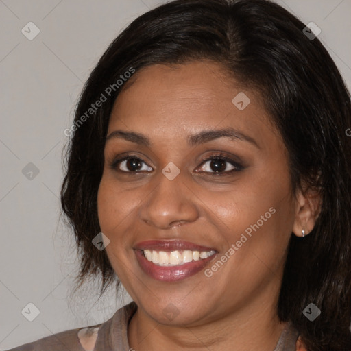 Joyful black young-adult female with medium  brown hair and brown eyes