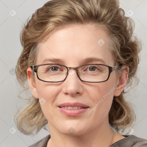 Joyful white adult female with medium  brown hair and blue eyes