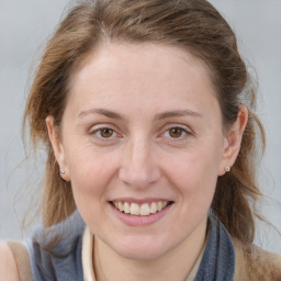 Joyful white adult female with medium  brown hair and blue eyes