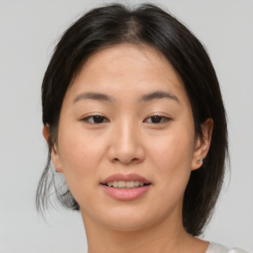 Joyful asian young-adult female with medium  brown hair and brown eyes