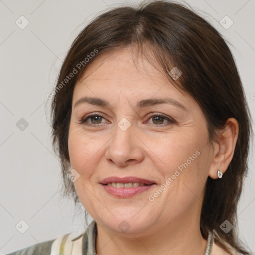 Joyful white adult female with medium  brown hair and brown eyes