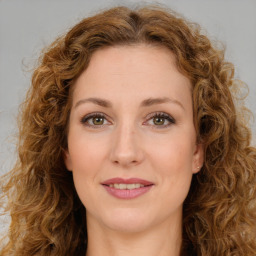 Joyful white young-adult female with long  brown hair and green eyes