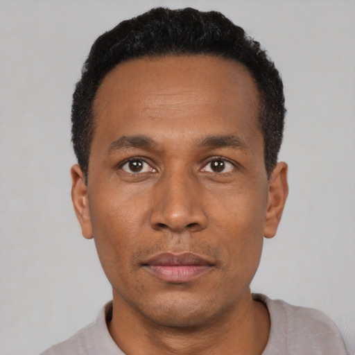 Neutral black adult male with short  black hair and brown eyes