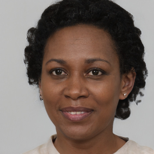 Joyful black adult female with short  black hair and brown eyes
