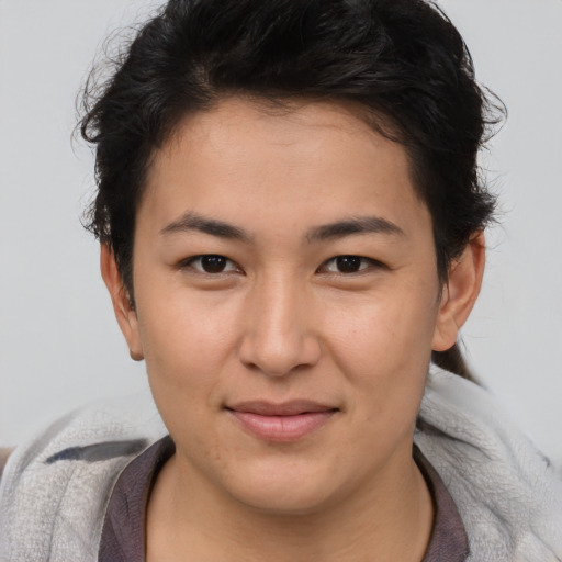 Joyful asian young-adult female with short  brown hair and brown eyes