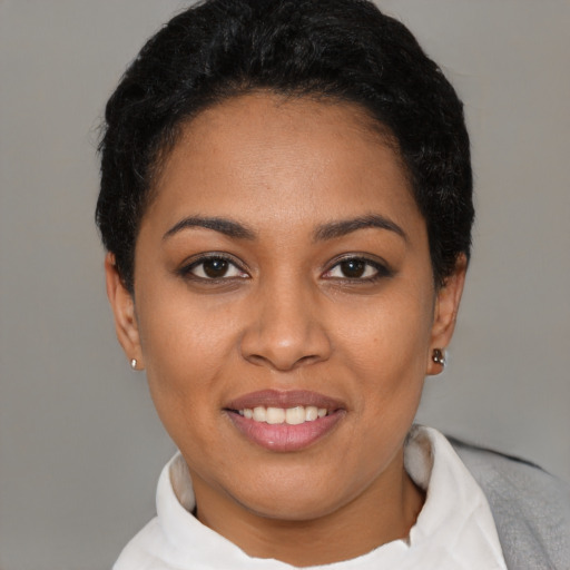 Joyful latino young-adult female with short  black hair and brown eyes