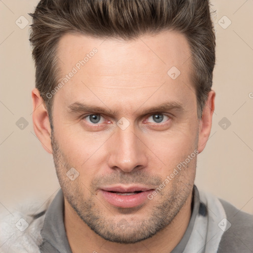 Joyful white adult male with short  brown hair and brown eyes