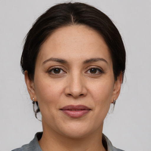 Joyful white adult female with medium  brown hair and brown eyes