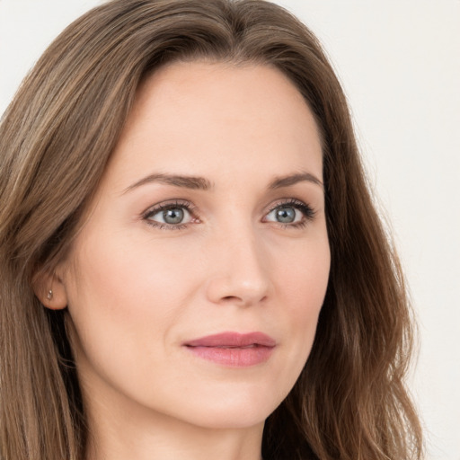 Joyful white young-adult female with long  brown hair and green eyes