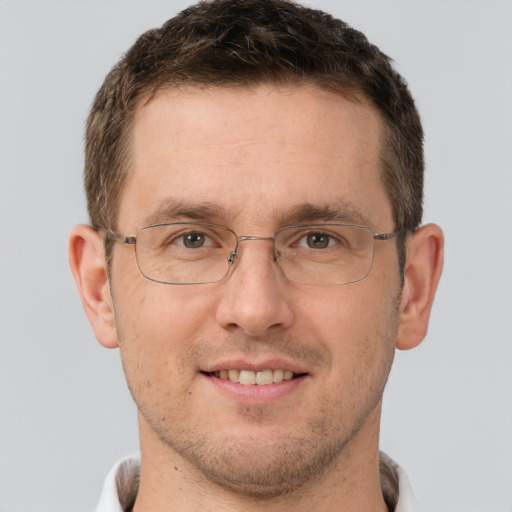 Joyful white adult male with short  brown hair and brown eyes