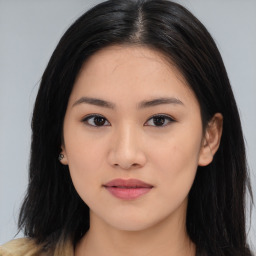 Joyful asian young-adult female with long  brown hair and brown eyes