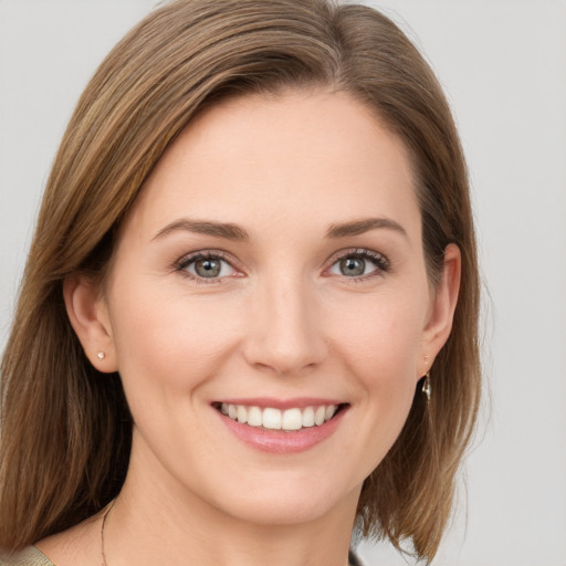 Joyful white young-adult female with medium  brown hair and blue eyes