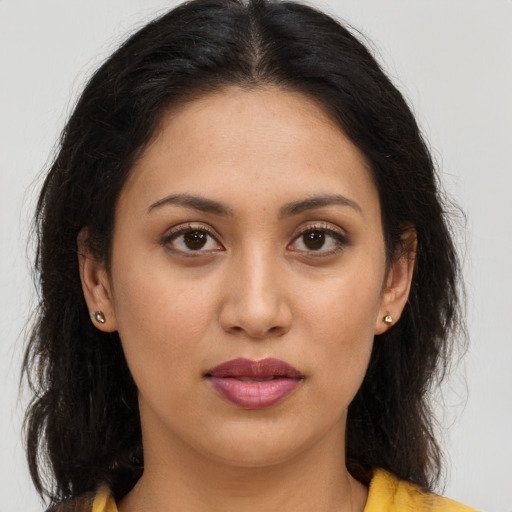 Joyful latino young-adult female with long  brown hair and brown eyes
