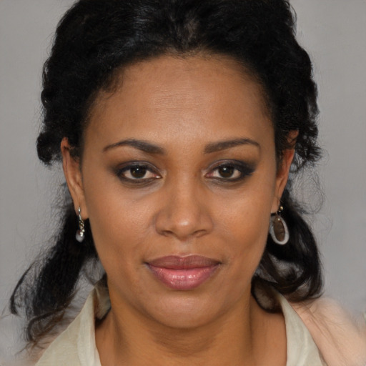 Joyful black adult female with medium  brown hair and brown eyes