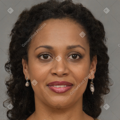 Joyful black adult female with medium  brown hair and brown eyes