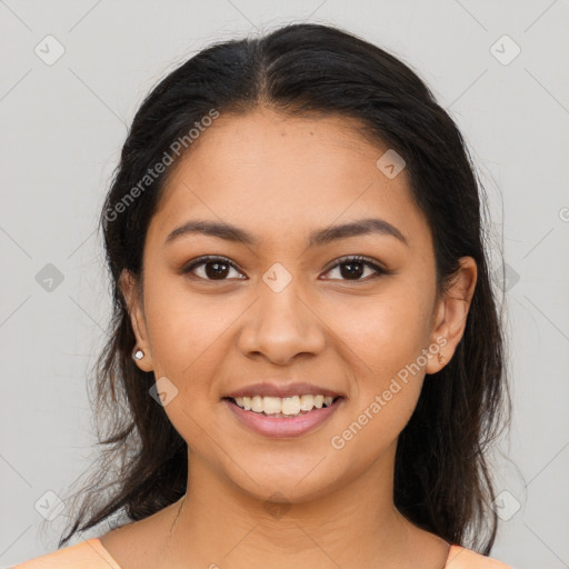 Joyful latino young-adult female with medium  brown hair and brown eyes