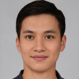 Joyful asian young-adult male with short  brown hair and brown eyes