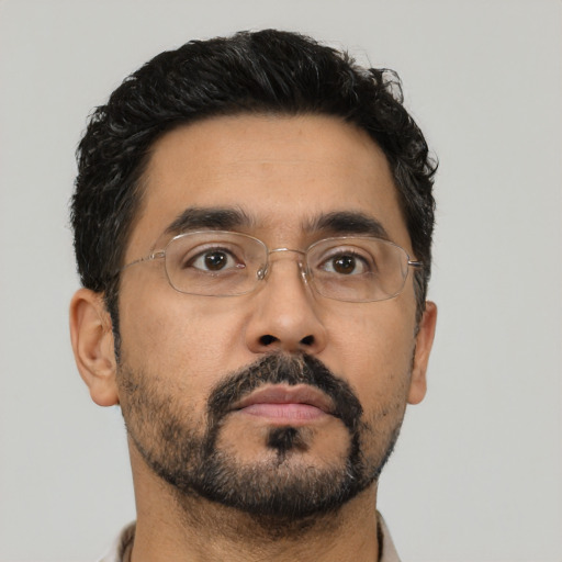 Neutral latino adult male with short  brown hair and brown eyes
