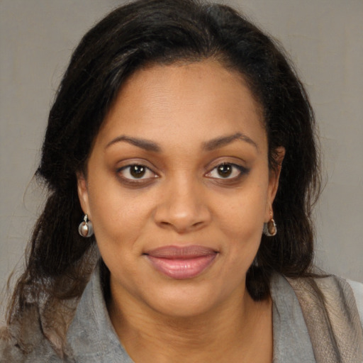 Joyful black young-adult female with medium  brown hair and brown eyes