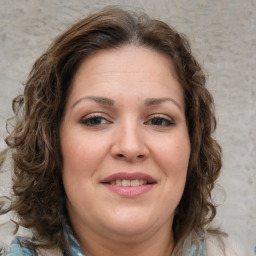 Joyful white young-adult female with medium  brown hair and green eyes