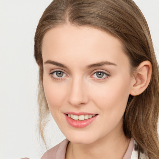 Joyful white young-adult female with long  brown hair and grey eyes