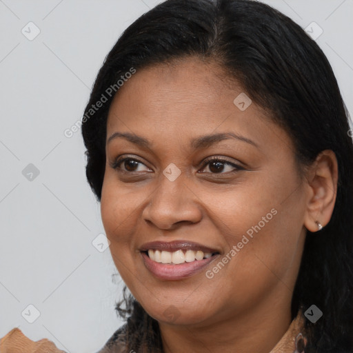 Joyful latino young-adult female with long  brown hair and brown eyes