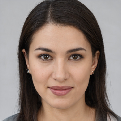 Joyful white young-adult female with long  brown hair and brown eyes