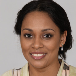 Joyful black young-adult female with medium  brown hair and brown eyes