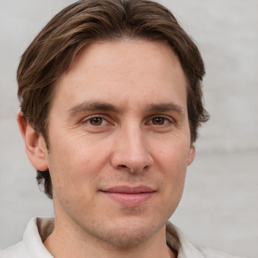 Joyful white adult male with short  brown hair and grey eyes