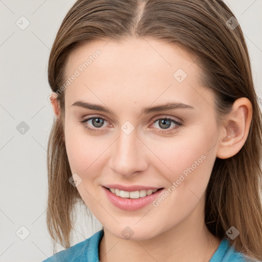 Joyful white young-adult female with medium  brown hair and blue eyes