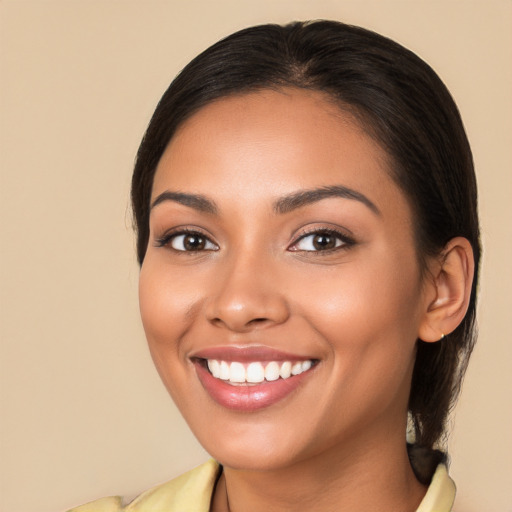 Joyful latino young-adult female with long  brown hair and brown eyes