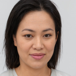 Joyful asian young-adult female with medium  brown hair and brown eyes