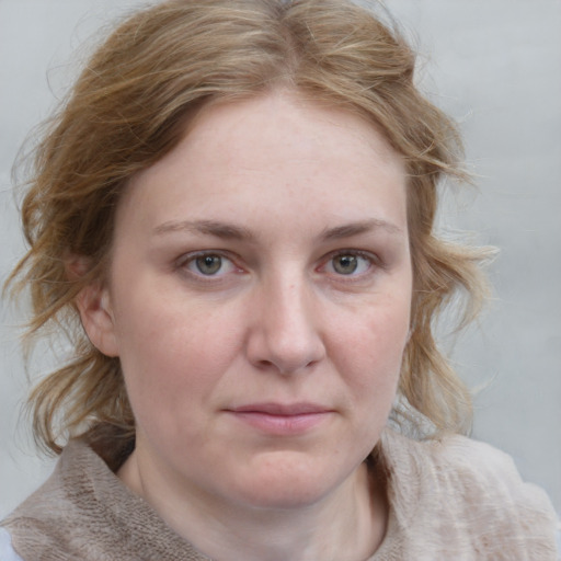 Joyful white young-adult female with medium  brown hair and blue eyes