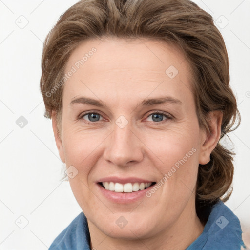 Joyful white adult female with medium  brown hair and grey eyes