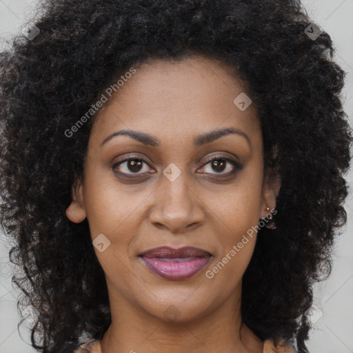 Joyful black adult female with long  brown hair and brown eyes