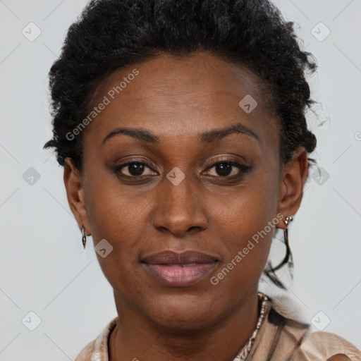 Joyful black adult female with short  brown hair and brown eyes