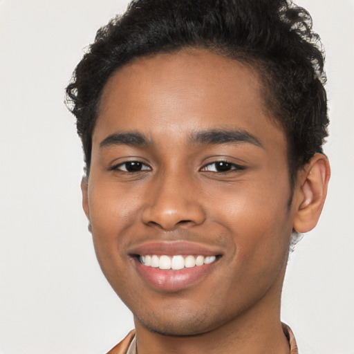 Joyful black young-adult male with short  brown hair and brown eyes