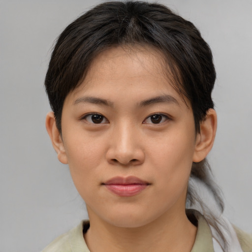 Joyful asian young-adult female with short  brown hair and brown eyes