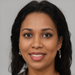 Joyful latino young-adult female with long  brown hair and brown eyes