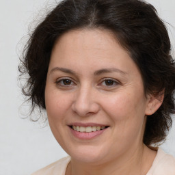 Joyful white adult female with medium  brown hair and brown eyes