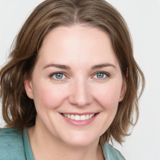 Joyful white young-adult female with medium  brown hair and blue eyes