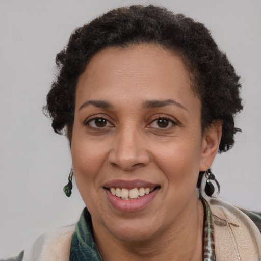 Joyful latino adult female with short  brown hair and brown eyes