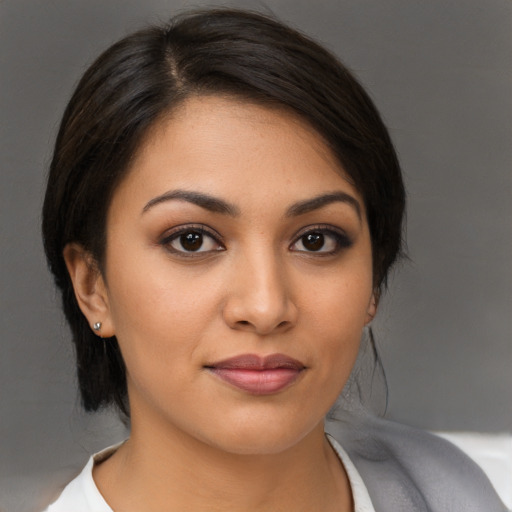Joyful latino young-adult female with medium  brown hair and brown eyes